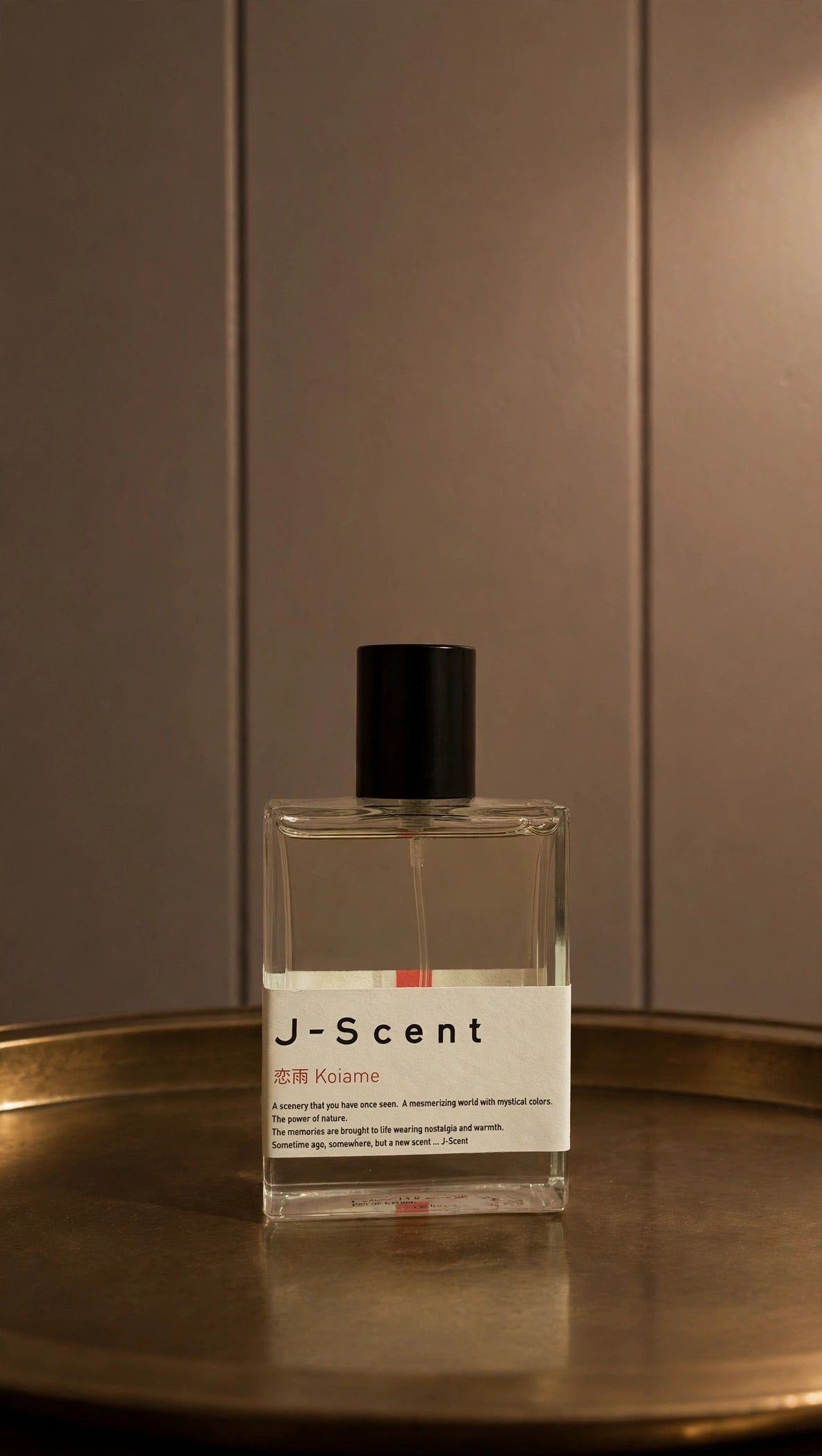 Koiame by J-Scent perfume bottle on a brass tray